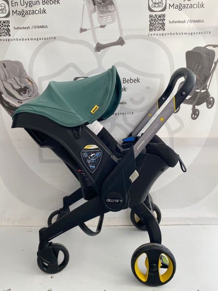 Doona Max Bebek Arabasına Dönüşen Tekerlekli Gr 0 Bebek Ana Kucağı Oto Koltuğu - Yeşil
